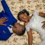 man in blue jacket and woman in white wedding gown